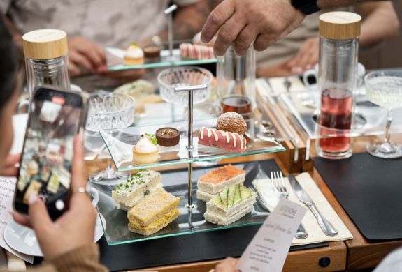 cake stand on table for afternoon tea on bustronome london
