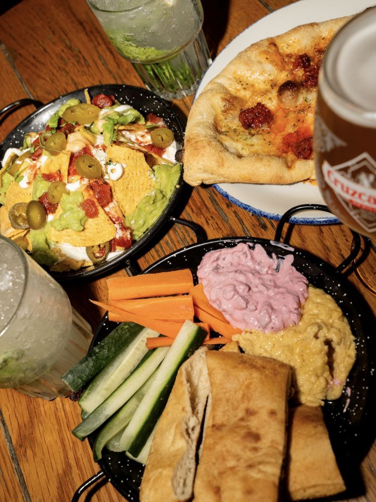 plates of food with drinks for a bottomless drinks with food experience at revolution bars
