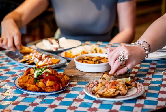 ladies eating tapas dishes at revolucion de cuba