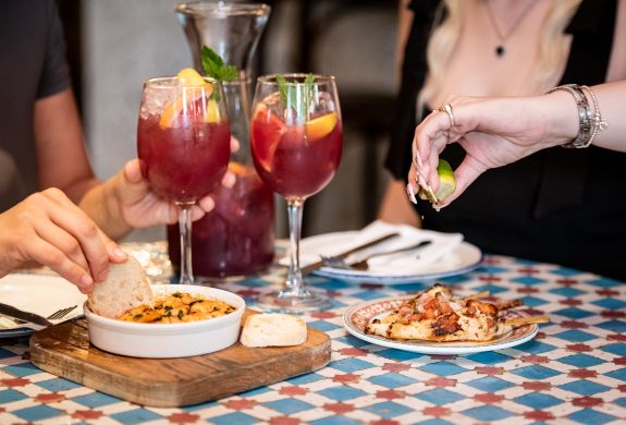 two ladies with jug of sangria and tapas at revolucion de cuba