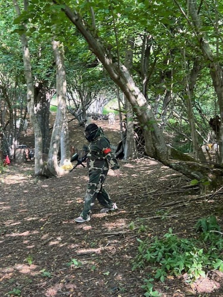 Walking through trees on paintball course