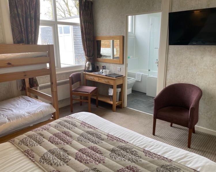 Standard family room with bunk beds and view into bathroom