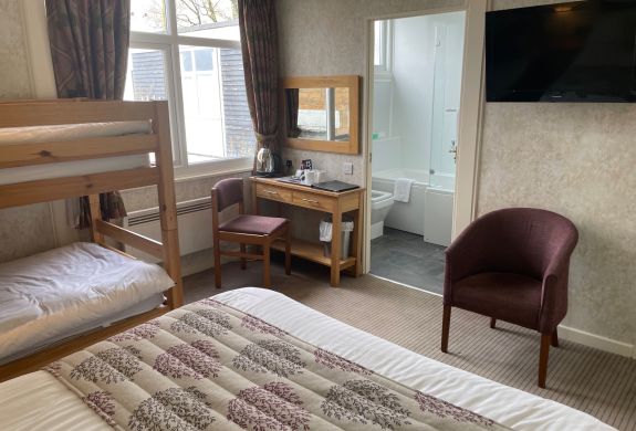 Standard family room with bunk beds and view into bathroom