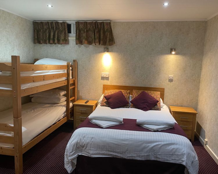 Double bed with bunk beds in standard family room