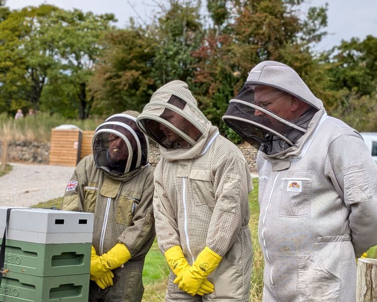 group being shown the hives on a beekeeping experience in yorkshire