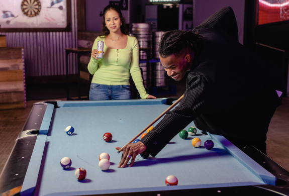 two people playing pool at boom battle bar
