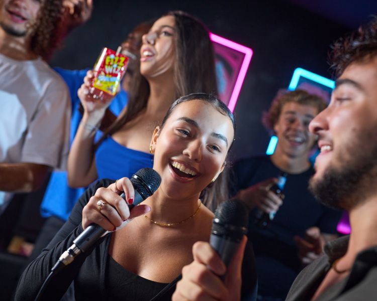 young people singing karaoke at a boom battle bar