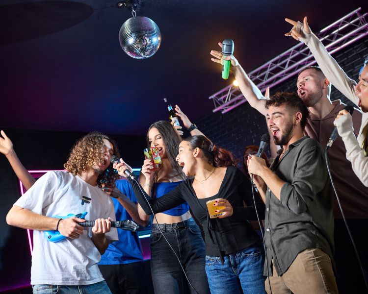 young people singing karaoke at a boom battle bar