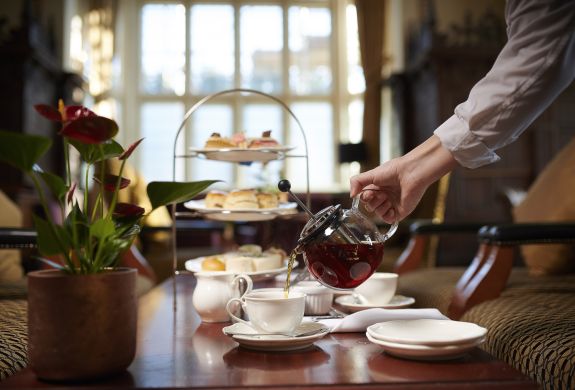 afternoon tea at crewe hall with tea being poured into teacup