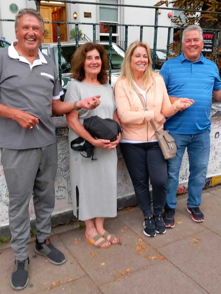 four people outside abbey road studios on the beatles walking tour In london