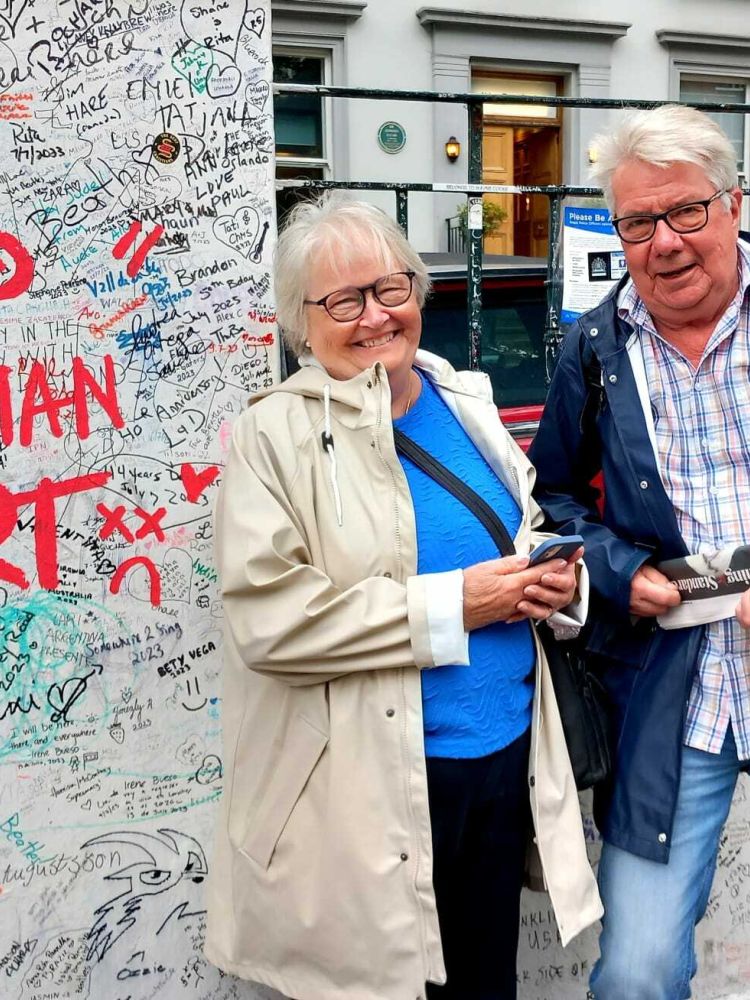 couple outside abbey road studios on the beatles walking tour In london