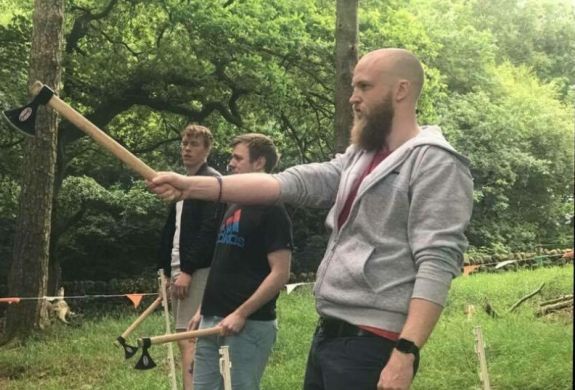 man preparing to throw an axe at the target on an axe throwing experience day