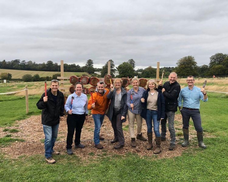 Group of people posing with axes on an axe throwing experience