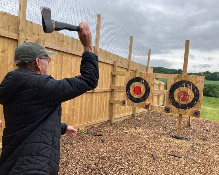 Man throwing axe on axe throwing experience