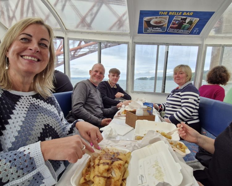 ladies enjoying fish and chips on a river cruise