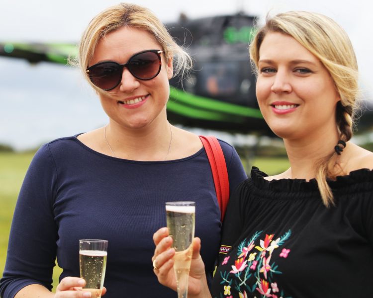two ladies each holding a glass of prosecco