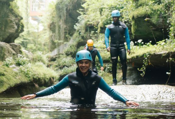 Lady smiling in water while gorge walking