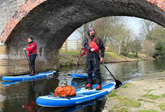 Instructor smiling while sup boarding