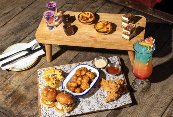 afternoon tea spread with a cocktail at revolution bars