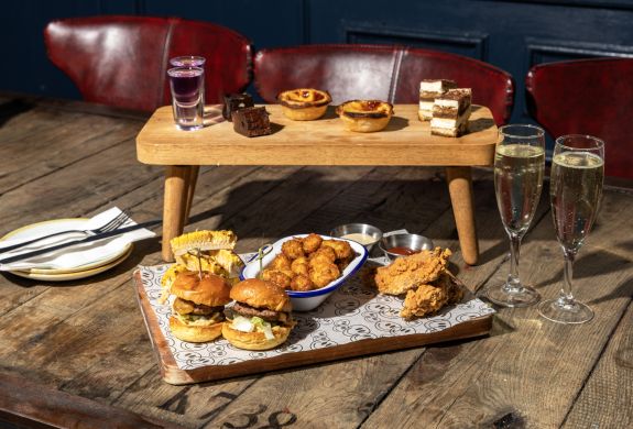 revolution bars afternoon tea spread with glasses of prosecco
