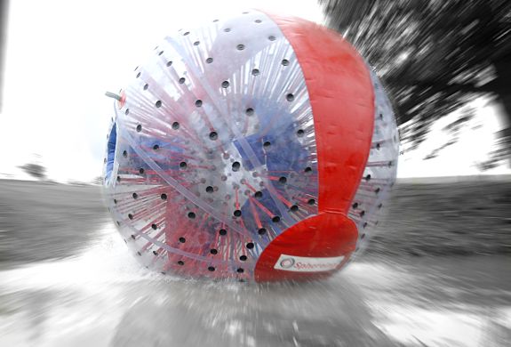 an aqua sphere rolling down the hill as part of an aqua sphereing experience day