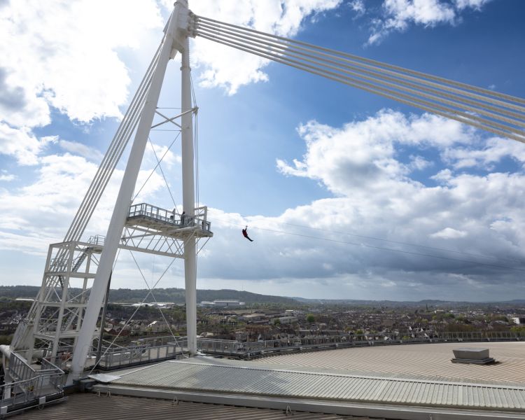 person on the zip world stadium flyer zip line experience at the principality stadium in cardiff