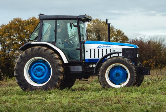 a lamborghini tractor being driven in a field on a tractor driving experience