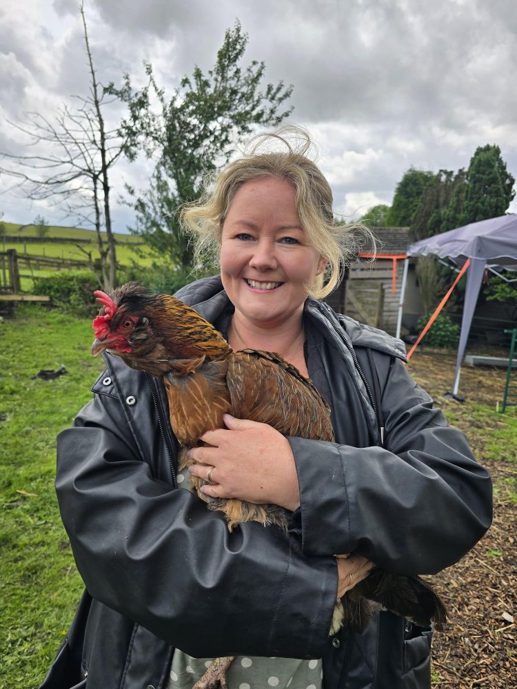 woman holding a chicken on a west yorkshire farm
