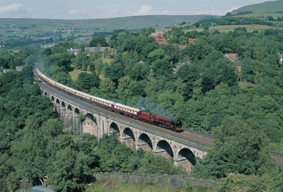 northern belle steam train travelling over a viaduct