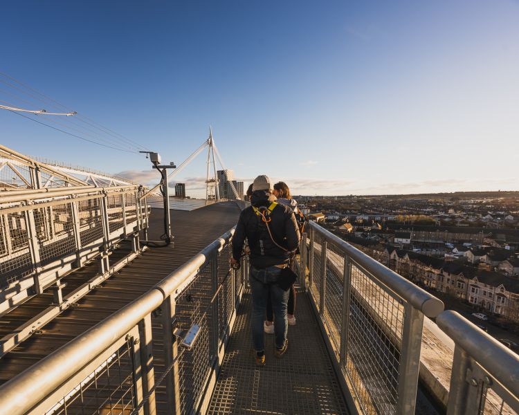 People walking along top of stadium at zip world cardiff