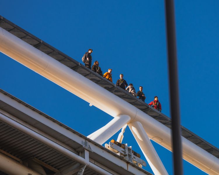people looking down from the stadium walk at zip world cardiff