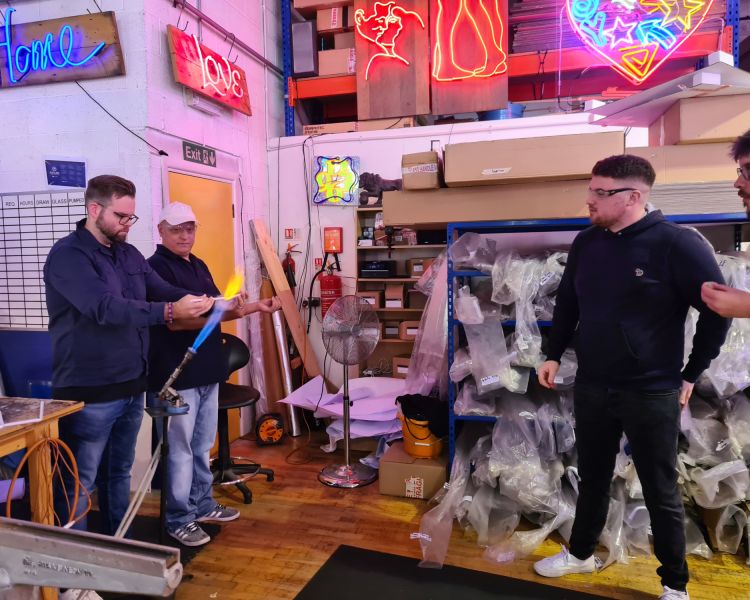 man having a go at glass bending on neon sign taster session
