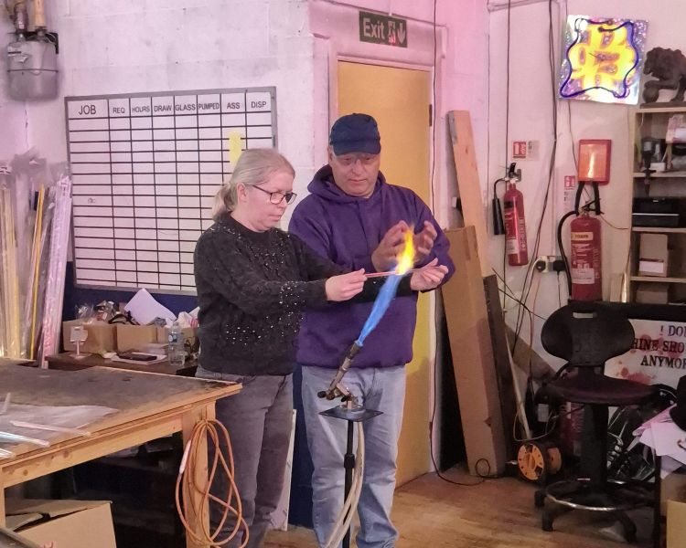 man being taught glass bending on neon sign taster session