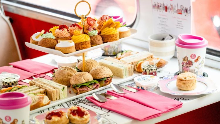 afternoon tea spread of cakes and sandwiches on an afternoon tea bus tour in london