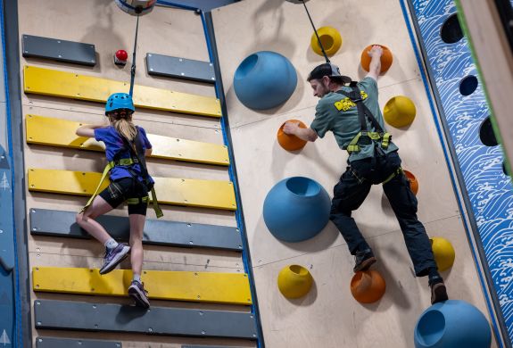 man and child on climbing wall at adventure climb experience in wales