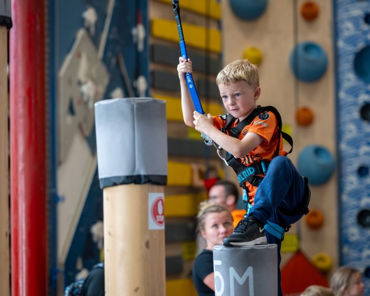 boy on adventure climb experience at activity centre in wales