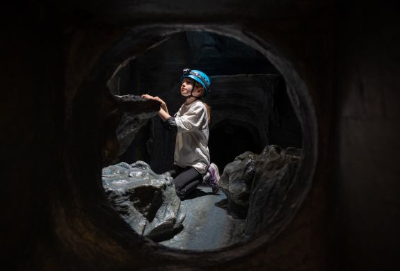 boy on indoor caving experience at activity centre in wales