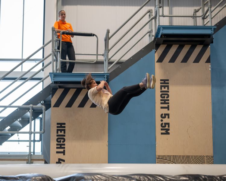 person jumping on adrenaline drop at activity centre in wales