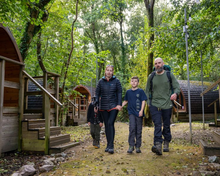 family walking from their pod on wales overnight stay at activity centre