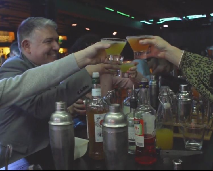 people saying cheers with cocktails at a cocktail class at inamo london