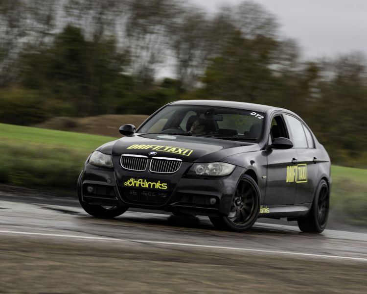 a bmw sports car on a race track for a drift battle driving experience