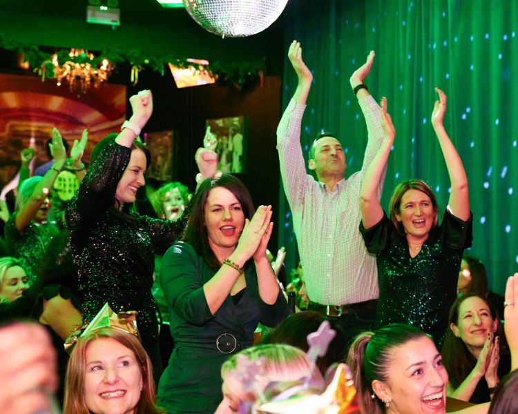 Crowd on their feet having fun at bingo in london