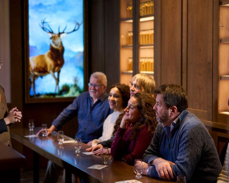 A guide and group of guests at the edinburgh whisky tour