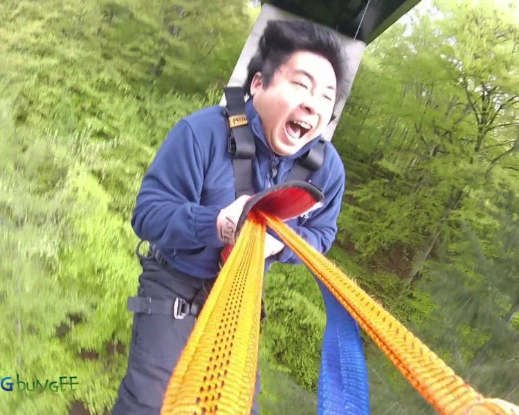 man on a bridge swinging experience day