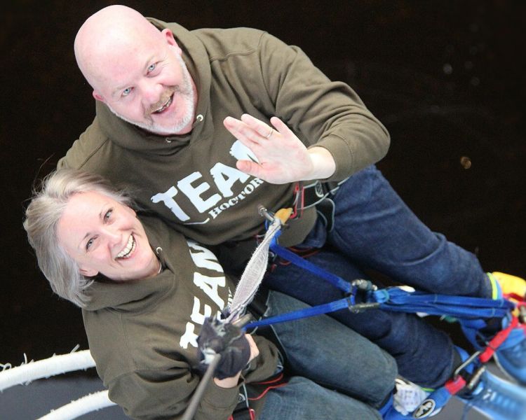 couple harnessed up ready for a bridge swinging experience