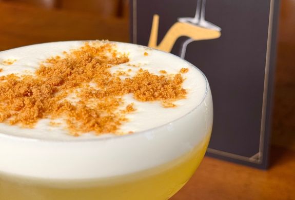 Close up of a cocktail and menu
