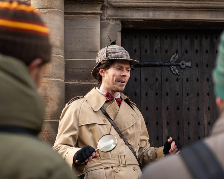 guide talking to group next to old wooden door on a historical walking tour in edinburgh