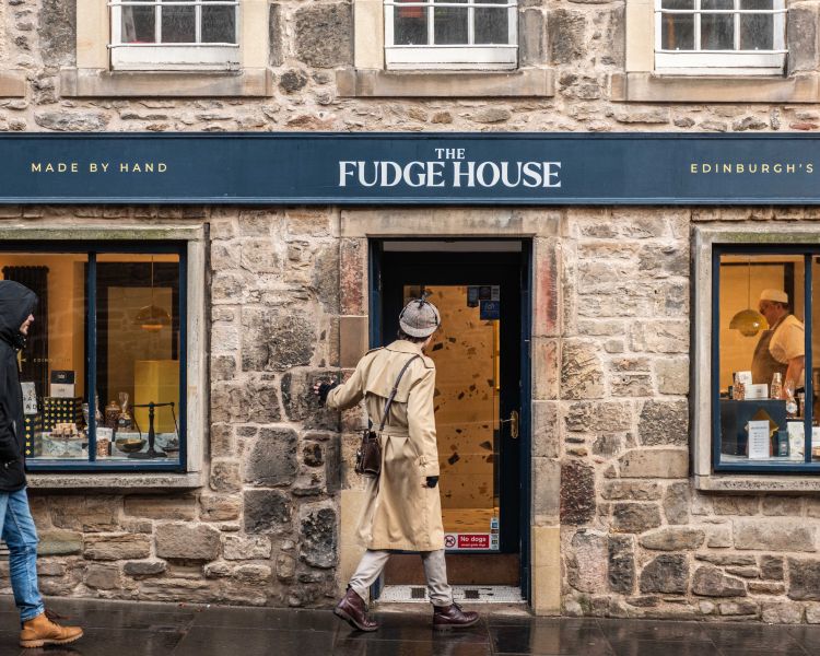 guide entering the fudge house shop on a historical walking tour in edinburgh