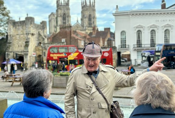 guide talking to group on a historical walking tour in york