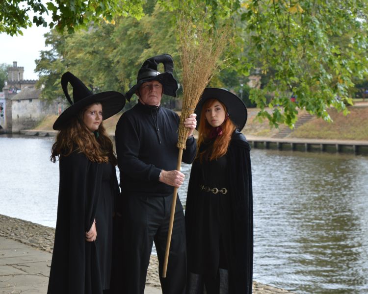 three guides dressed as witches on a witches walking tour in york